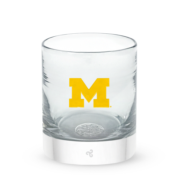 Michigan rocker, clear hand-blown lowball drinking glass with University of Michigan hand-etched in yellow.