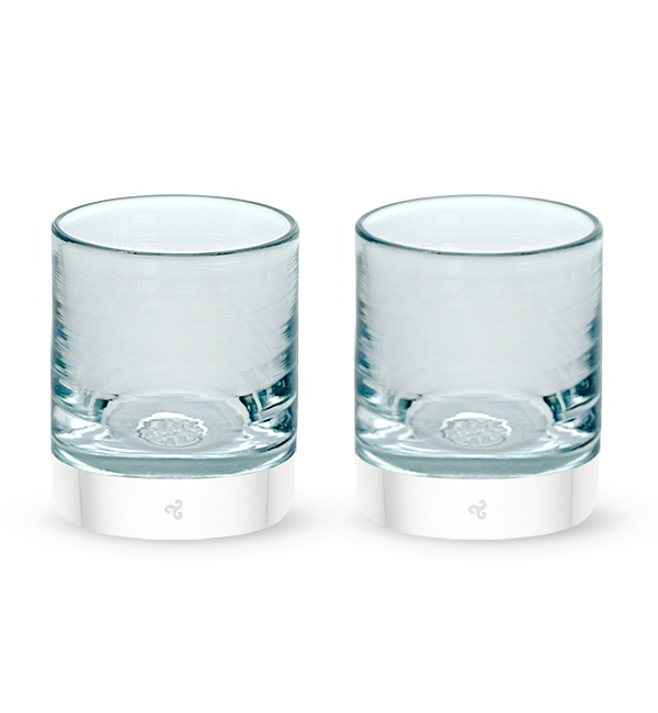 two Clarity rockers, clear with light blue hues hand-blown glass lowball drinking glasses.