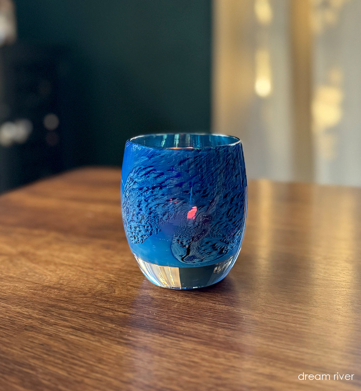 blue with intricate textures hand-blown glass votive candle holder on wood table