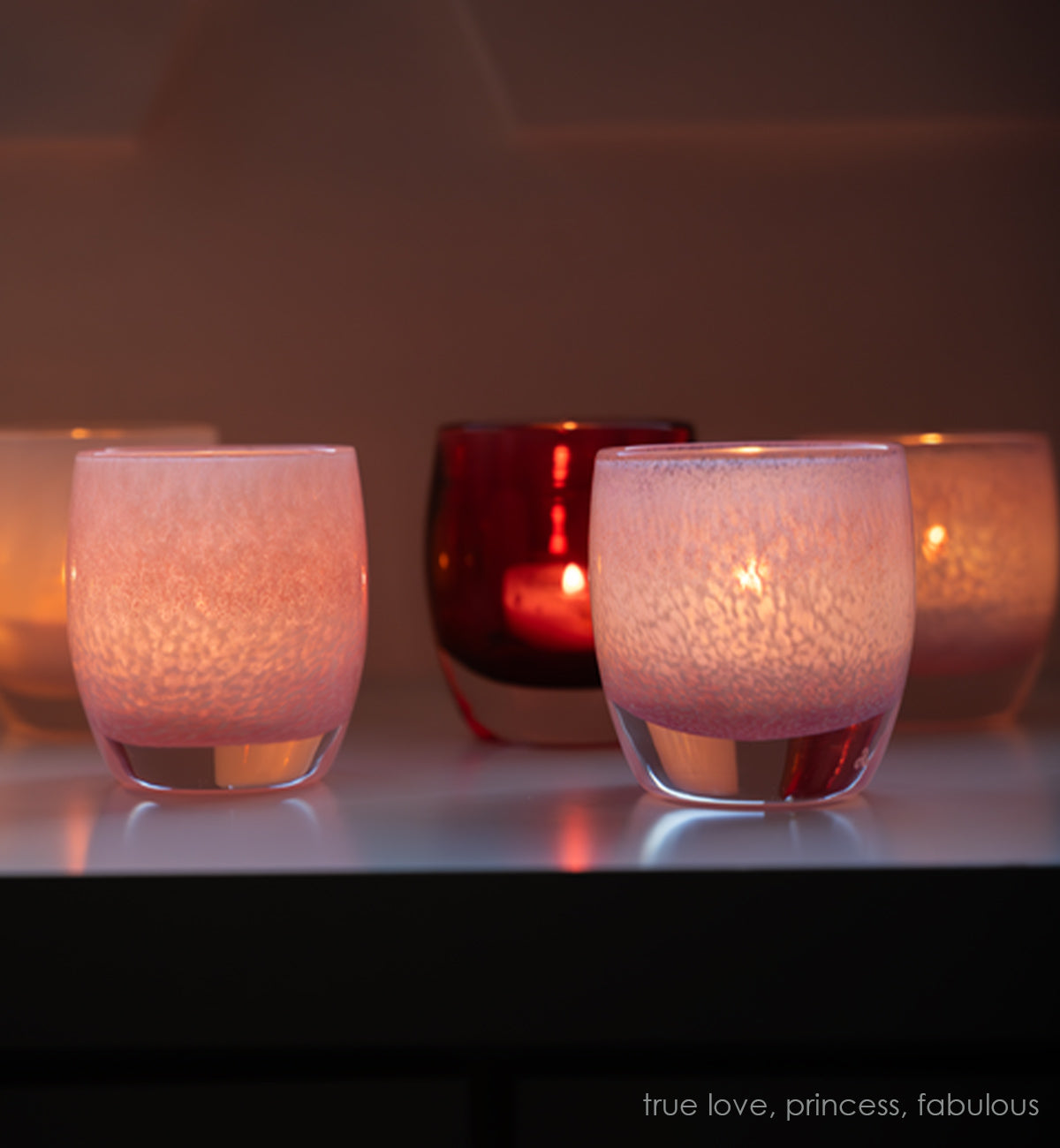 fabulous, pink textured hand-blown glass votive candle holders paired with true love and princess on a mantle.