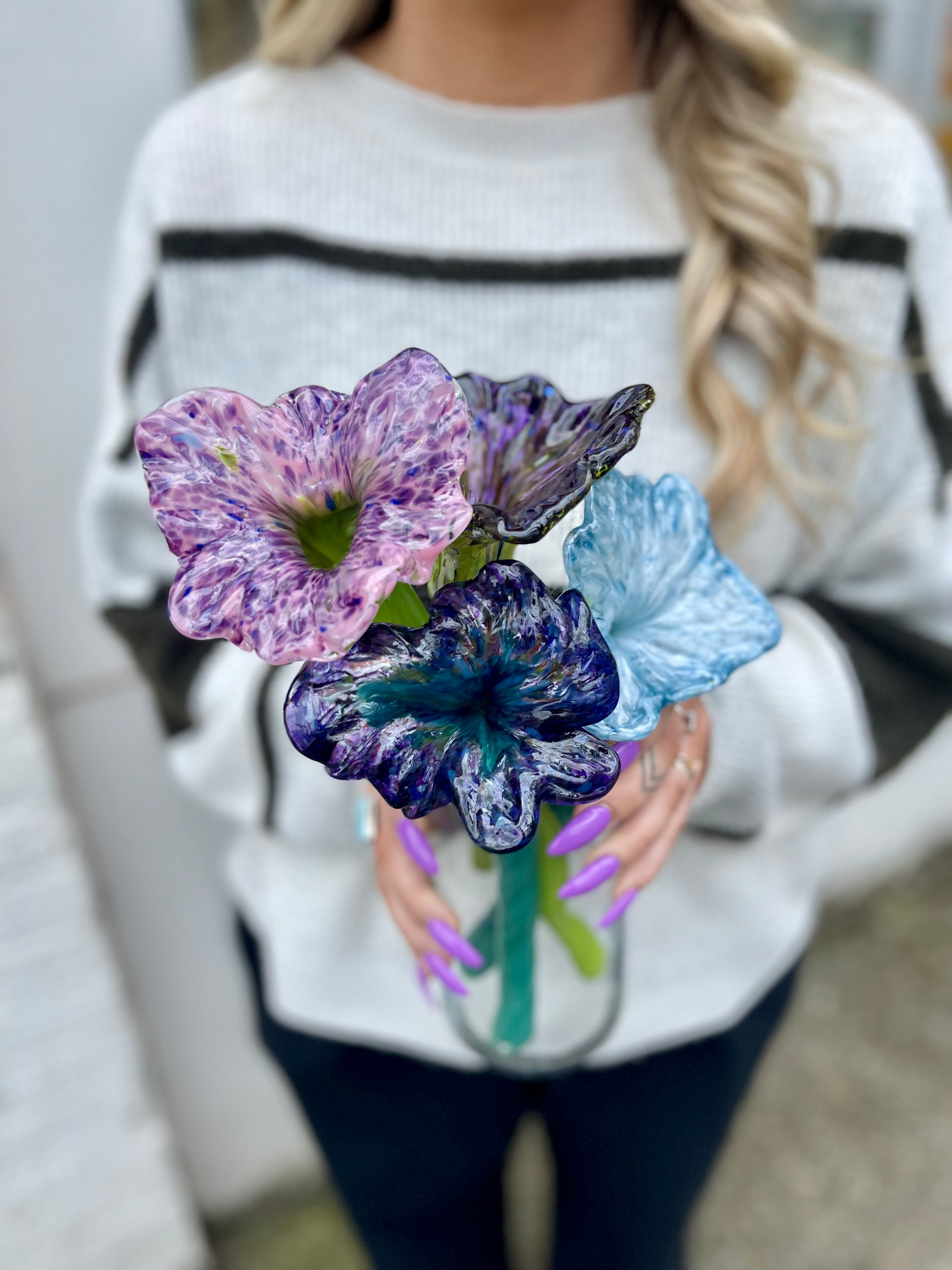 woman holding hand-blown glass flowers