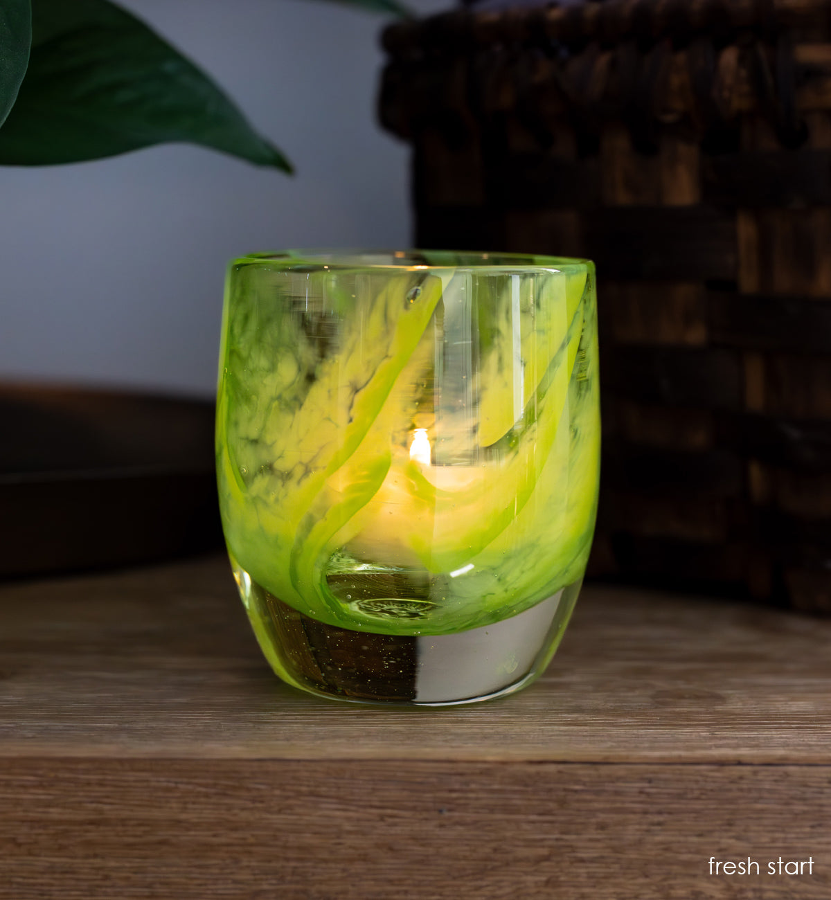 fresh start lime green hand-blown glass candle holder on wood desk