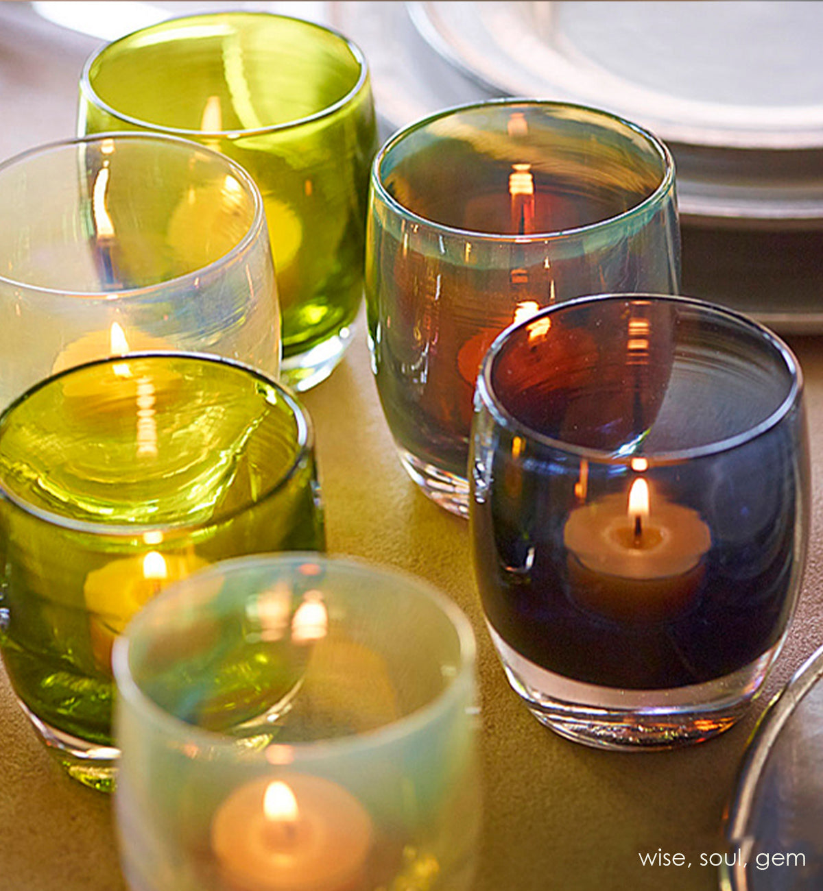 wise translucent deep gray with wisps of purple and yellow hand-blown glass votive candle holder. Paired with soul and gem on a set dining table.